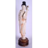 AN EARLY 20TH CENTURY CHINESE POLYCHROMED IVORY FIGURE OF A FEMALE modelled holding a musical