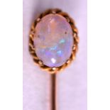 A LATE VICTORIAN GOLD AND OPAL TIE PIN. 6.5 cm long.