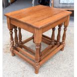 AN ANTIQUE OAK NEST OF TABLES, with turned legs and stretchers. 46 cm x 51 cm.