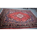 A LARGE RED GROUND HAMADAN RUG, decorated with extensive foliage.304 cm x 215 cm.
