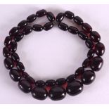 A 1930S CHERRY AMBER NECKLACE. 84 grams. 33 cm long.