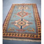 A TURKISH ANATOLIAN BERGAMA YORUK BLUE GROUND RUG, decorated with symbols and motifs. 210 cm x 150