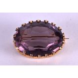 A LARGE GOLD AND AMETHYST BROOCH. 3 cm wide.