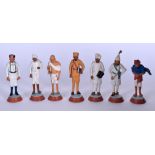 A SET OF SEVEN INDIAN SCHOOL CLAY FGURES, of varying form. 11 cm high.
