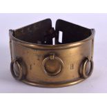 AN 18TH CENTURY BRASS AND LEATHER DOG COLLAR with engraved swirling motifs. 24 cm long.