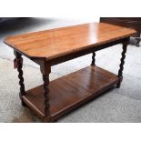 AN EARLY 20TH CENTURY OAK TWO TIER COFFEE TABLE, formed with carved twist supports. 51 cm x 90 cm.