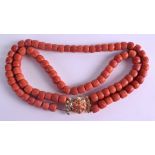 AN 18CT GOLD DOUBLE STRAND CORAL NECKLACE with open work foliate clasp. 192 grams. Each strand 40 cm