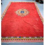 LARGE TURKISH/MOROCCAN RED GROUND RUG, decorated with central geometric floral inspired panel. 305