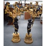 A LARGE PAIR OF BRONZE ORMOLU MOUNTED SIX BRANCH CANDELABRA, held aloft by bronze cherubs on