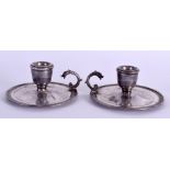 A PAIR OF EARLY 20TH CENTURY INDO PERSIAN SILVER CHAMBER STICKS. 5.7 oz. 8 cm wide.