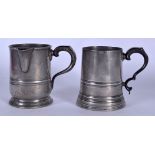 AN ANTIQUE PEWTER TANKARD, together with another similar. 12 cm high.