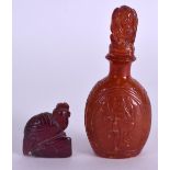 AN UNUSUAL 19TH CENTURY CARVED AMBER SNUFF BOTTLE AND STOPPER decorated with dancing buddhistic