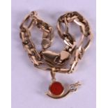 AN 18CT GOLD AND CORAL SNAIL CHARM upon a CT gold bracelet. 16.9 grams.