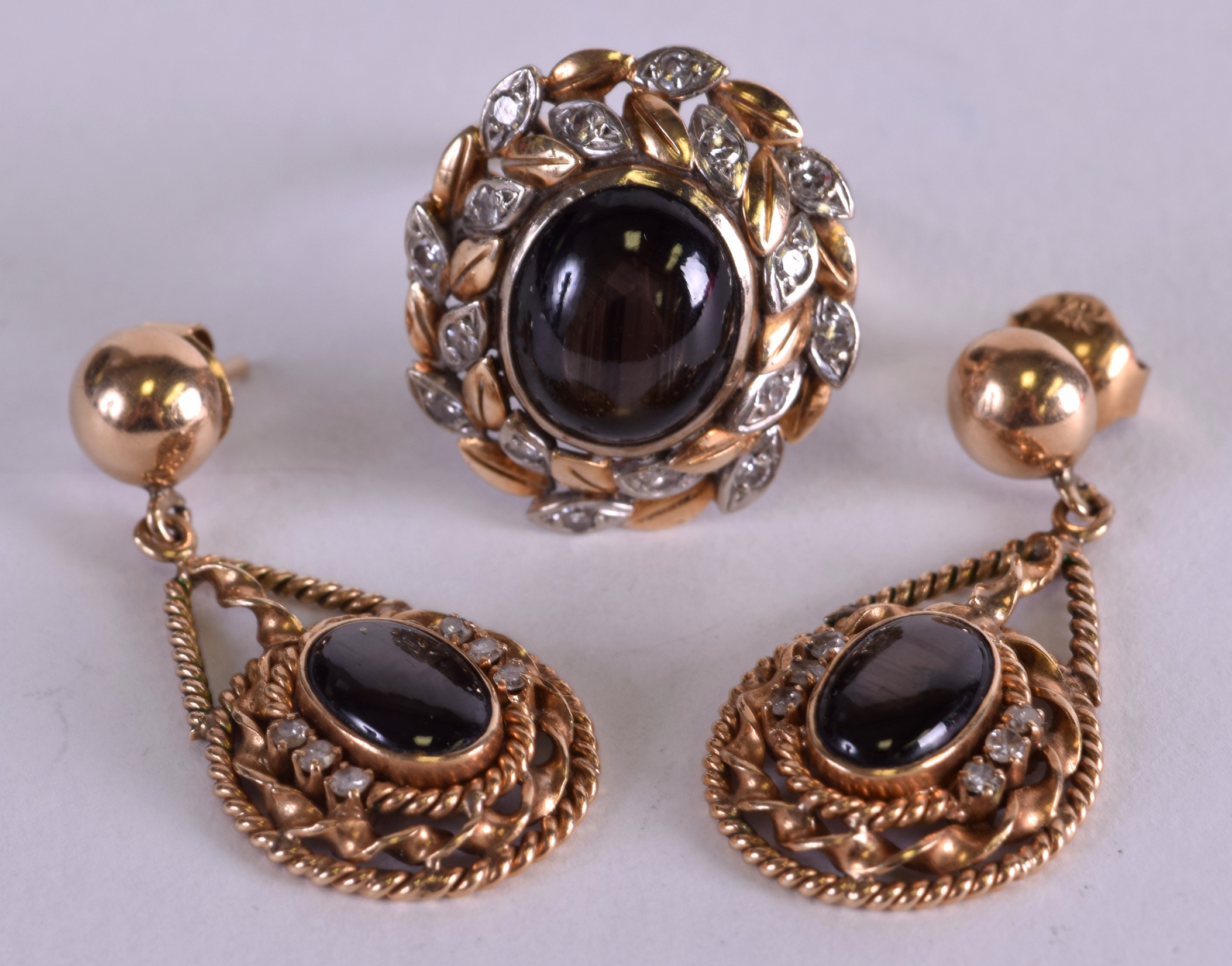 A 14CT GOLD BLACK SAPPHIRE AND DIAMOND RING with matching earrings. (3)