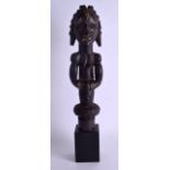 AN AFRICAN TRIBAL HARDWOOD FEMALE FERTILITY FIGURE with muscular arms and overlaid brass work.