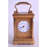 A MINIATURE LATE 19TH CENTURY ENGRAVED BRASS CARRIAGE CLOCK by Elliot & Son. 11 cm high inc handle.