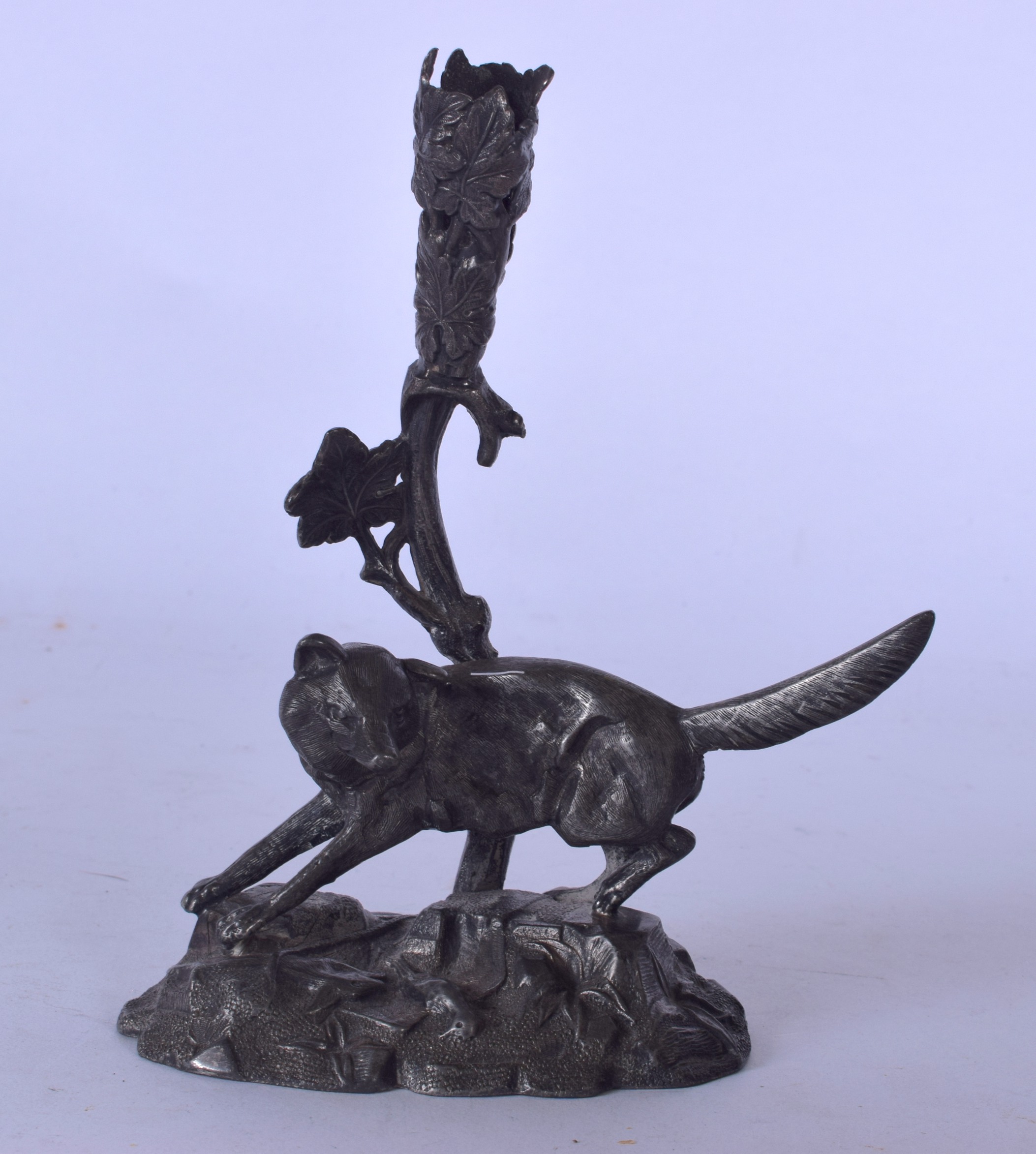 AN EARLY 20TH CENTURY PEWTER PEN HOLDER, in the form of a fox stood over dead game. 18 cm high.