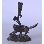AN EARLY 20TH CENTURY PEWTER PEN HOLDER, in the form of a fox stood over dead game. 18 cm high.