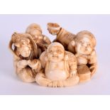 A SMALL 19TH CENTURY JAPANESE MEIJI PERIOD CARVED IVORY OKIMONO modelled as four seated figures in