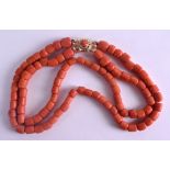 AN 18CT GOLD DOUBLE STRAND CORAL NECKLACE with open work foliate clasp. 96 grams. Each strand 32