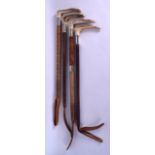 A GROUP OF FOUR 19TH CENTURY RIDING CROPS including a Swaine & Adeney. Longest 67 cm long. (4)