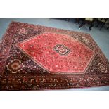 A LARGE PERSIAN THICK PILE SHIRAZ RUG, decorated with animals and extensive foliage, with