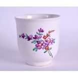 AN 18TH CENTURY ENGLISH PORCELAIN BEAKER painted with sparse floral sprays. 7.25 cm high.