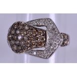A WHITE GOLD TWO TONE DIAMOND BUCKLE RING. Size M.