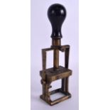 A MID 19TH CENTURY EBONY AND BRASS SWIVEL STAMPING SEAL with turned handle. 23 cm high.