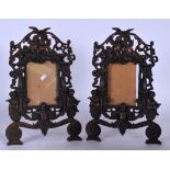 A PAIR OF BRONZE PICTURE FRAMES, decorated with cherubs in various pursuits. 36 cm high.