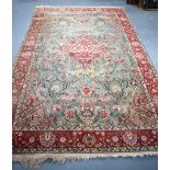 AN EARLY 20TH CENTURY PERSIAN VASE MOTIF RUG, decorated with extensive foliage. 285 cm x 180 cm.