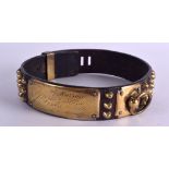 AN 18TH CENTURY BRASS AND LEATHER DOG COLLAR with open work brass plaque. 55 cm long.