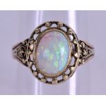 A YELLOW GOLD AND OPAL RING. Size K/L.