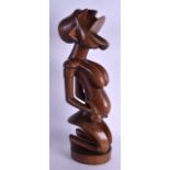 A LARGE EARLY 20TH CENTURY CARVED TRIBAL FERTILITY FIGURE modelled as a circular base. 56 cm high.