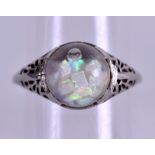 AN 18CT WHITE GOLD AND FLOATING OPAL RING. Size N.