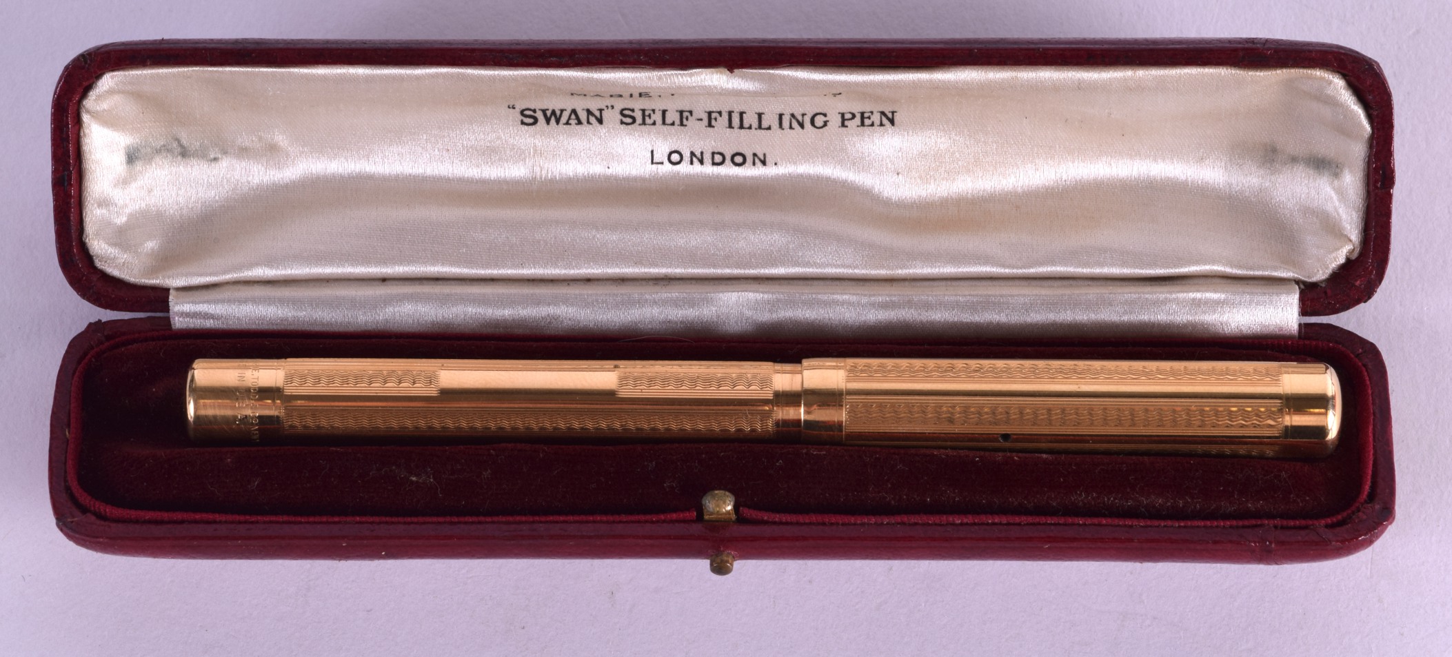 A CASED YELLOW METAL MABIE, TODD & CO SWAN SELF FILLING PEN. 21 grams.