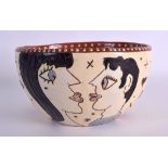 AN UNUSUAL SLIP DECORATED POTTERY BOWL decorated with stylised portraits and love