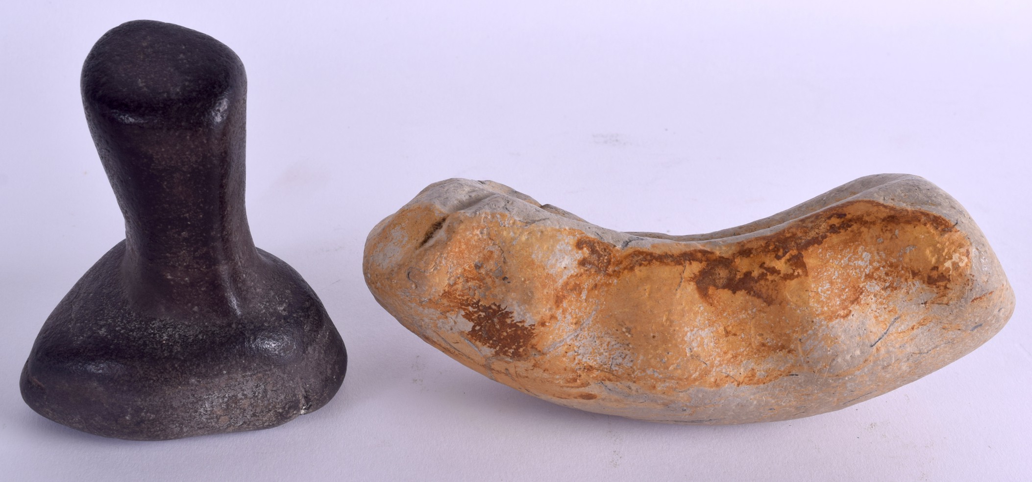 AN EARLY STONE AGE PESTLE together with an unusual hand held white stone tool. Pestle 10 cm high,