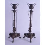 A PAIR OF 19TH CENTURY FRENCH BRONZE CANDLESTICKS modelled upon tapering columns, the bases with