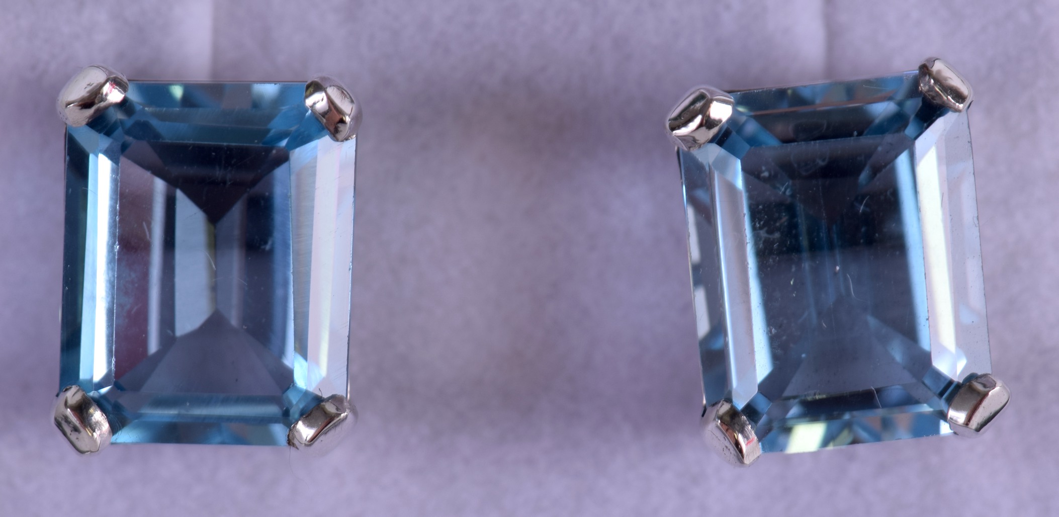 A PAIR OF SILVER EMERALD CUT BLUE TOPAZ EARRINGS.