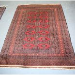 A SMALL RED GROUND RUG, finely woven and decorated with motifs. 177 cm x 122 cm.