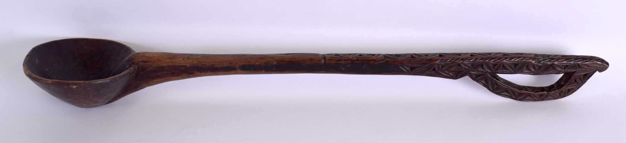 A LATE 19TH CENTURY AFRICAN TRIBAL CARVED WOOD SPOON with engraved terminal. 54 cm long.