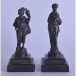 A PAIR OF 19TH CENTURY EUROPEAN BRONZE FIGURES OF A MALE AND FEMALE modelled upon a stepped base.