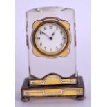 A SMALL STYLISH ART DECO SILVER ENAMEL AND GLASS CLOCK with white enamel banding and stylised yellow