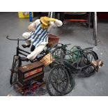 A MODEL OF A BUTCHER RIDING A BIKE, together with two other bicycles.