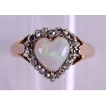 AN ANTIQUE GOLD DIAMOND AND OPAL HEART SHAPED RING. Size P.