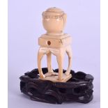 AN EARLY 19TH CENTURY JAPANESE EDO PERIOD CARVED IVORY NETSUKE in the form of a censer upon a table.