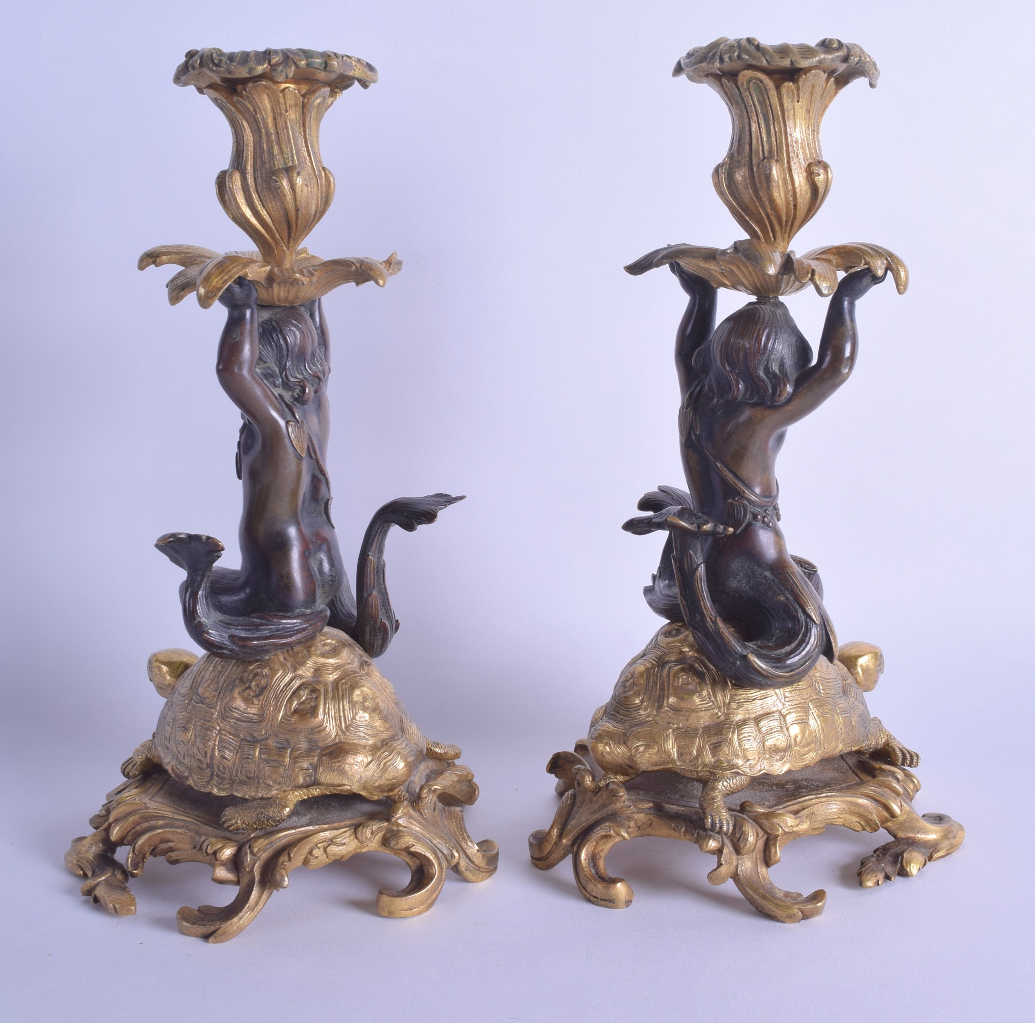 A PAIR OF MID 19TH CENTURY FRENCH BRONZE AND ORMOLU CANDLESTICKS modelled as putti resting upon - Bild 2 aus 4