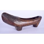 AN UNSUAL CARVED TRIBAL WOODEN SHOE, with thatch work type decoration to front. 33 cm long.