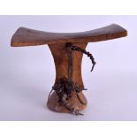 AN EARLY 20TH CENTURY AFRICAN TRIBAL CARVED WOODEN HEAD REST of plain form with leather mounts. 21